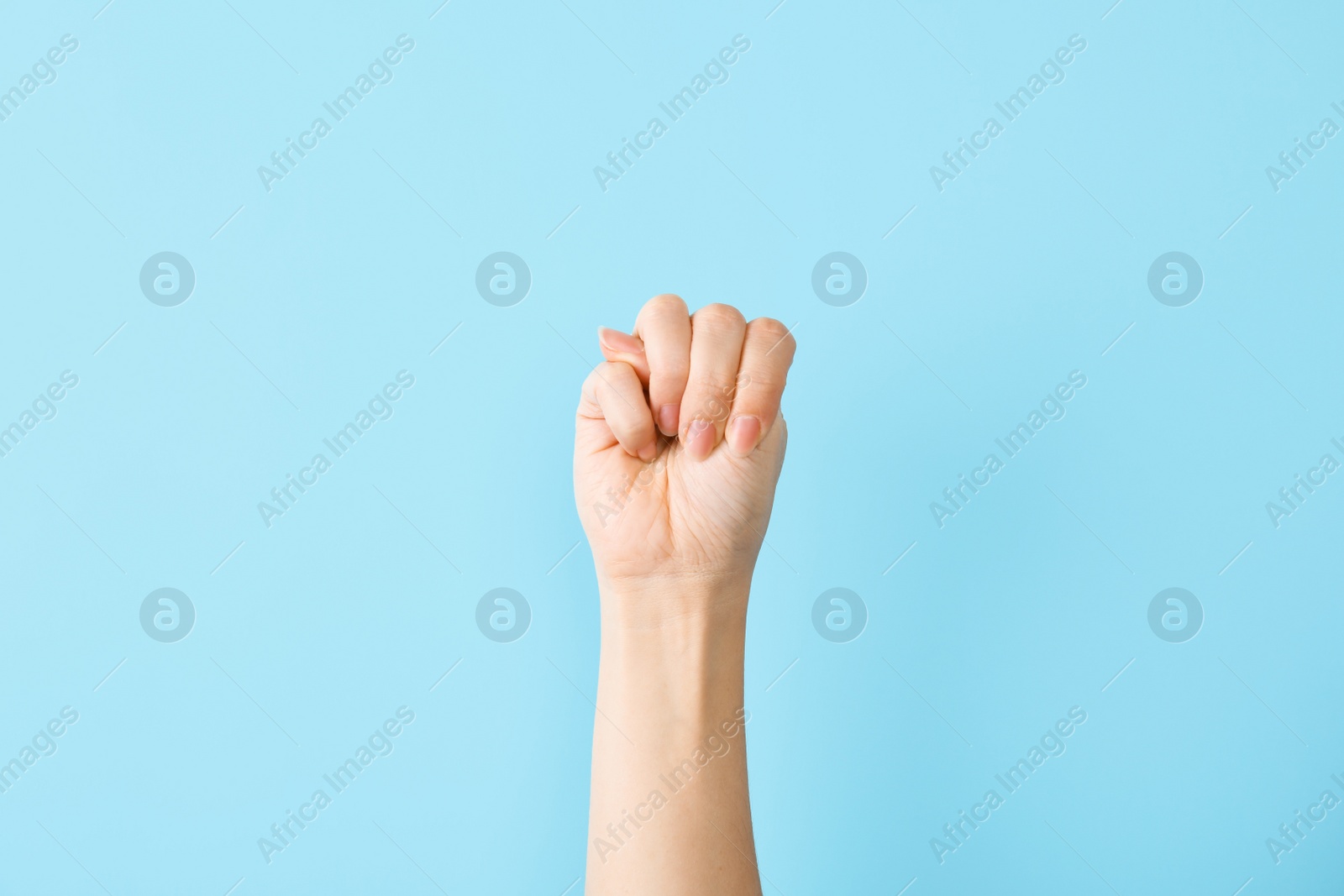 Photo of Woman showing M letter on color background, closeup. Sign language