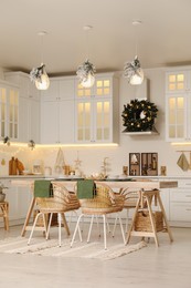 Cozy open plan kitchen decorated for Christmas. Interior design