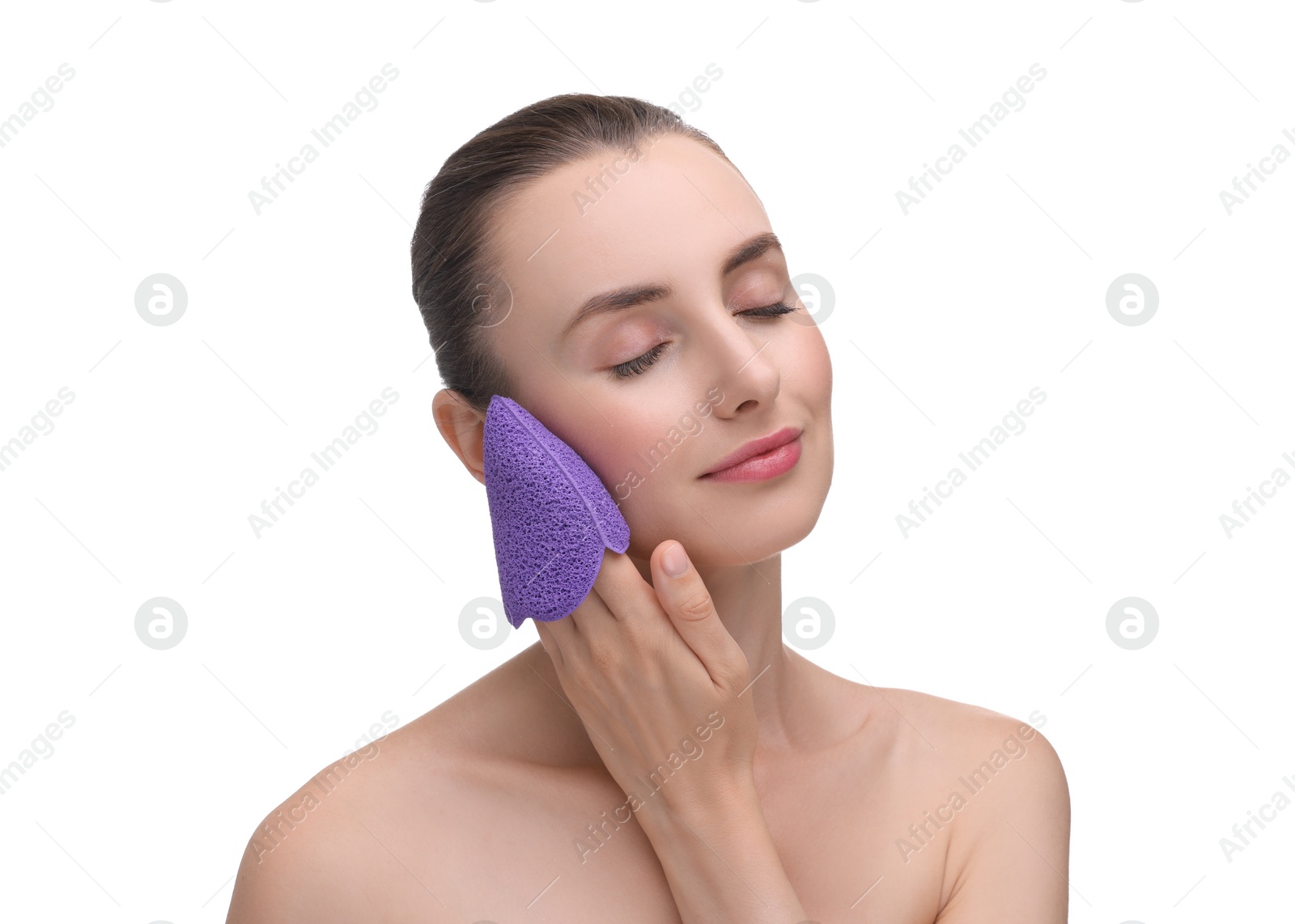 Photo of Young woman washing her face with sponge on white background