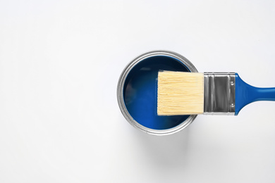 Can of paint and brush on white background, top view. Color of the year 2020 (Classic blue)