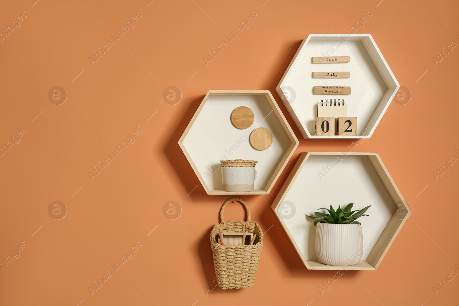 Photo of Shelves with decorative elements on color wall. Space for text