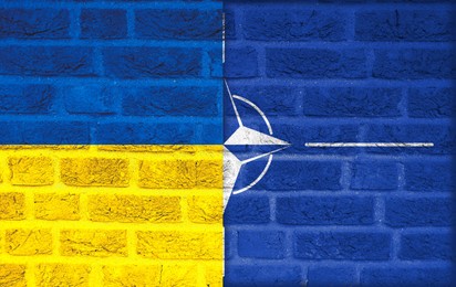 Flags of Ukraine and NATO on brick wall, banner design