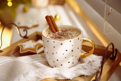 Composition with cup of hot drink on windowsill