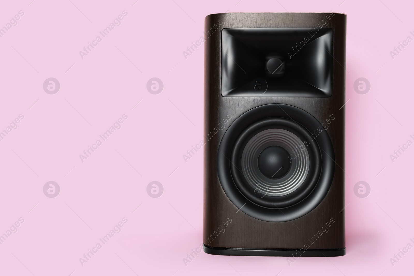 Photo of One wooden sound speaker on pink background. Space for text