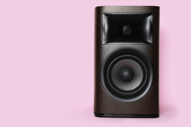 Photo of One wooden sound speaker on pink background. Space for text