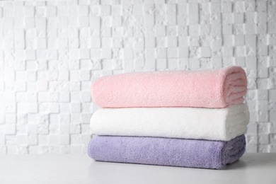 Stack of soft bath towels on table