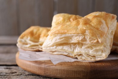 Delicious puff pastry on table, closeup view