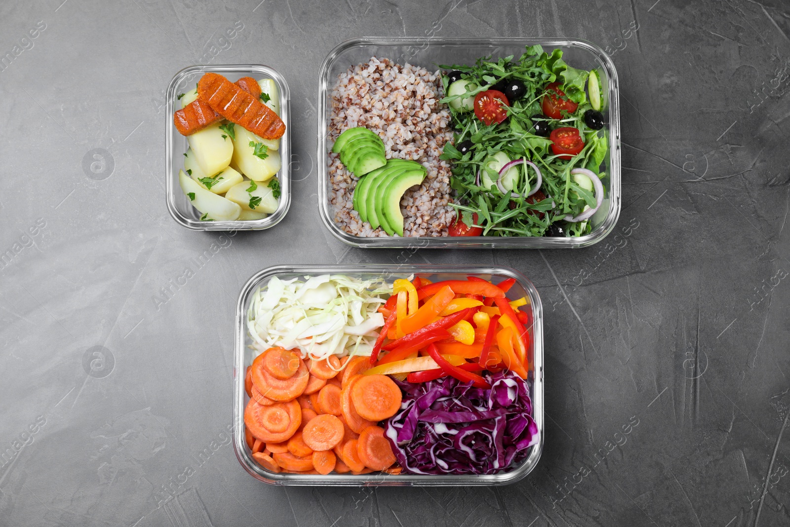 Photo of Set of glass containers with fresh food on grey table, flat lay