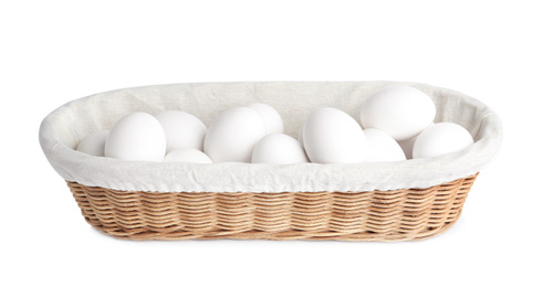 Photo of Chicken eggs in wicker bowl isolated on white