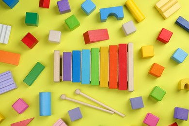 Photo of Different children's toys on yellow background, flat lay