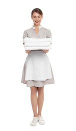 Full length portrait of chambermaid with towels on white background