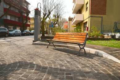 Beautiful view of wooden bench on city street