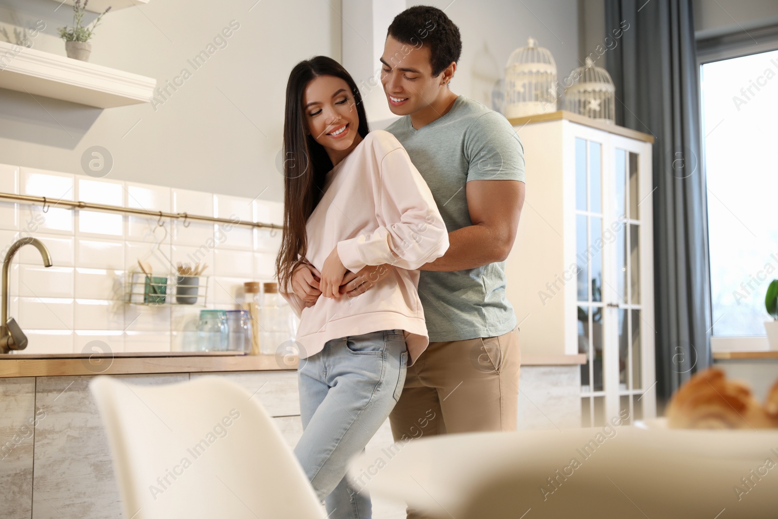 Photo of Lovely young interracial couple dancing at home