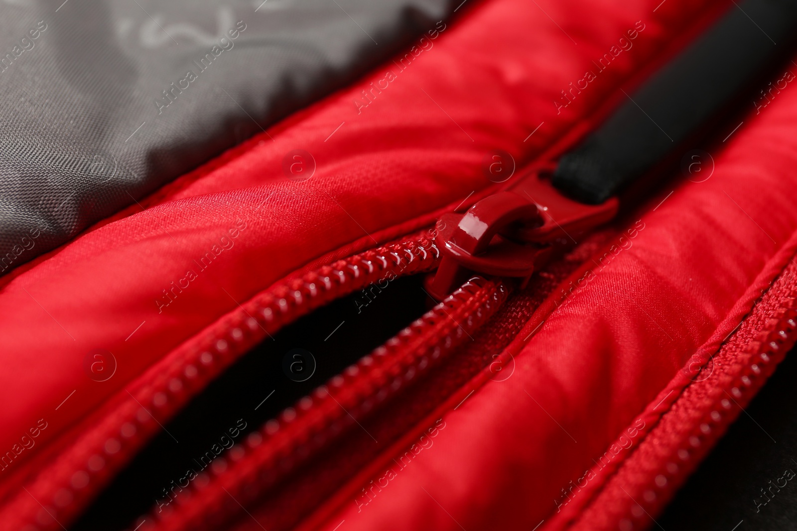 Photo of Red jacket with zipper as background, closeup view