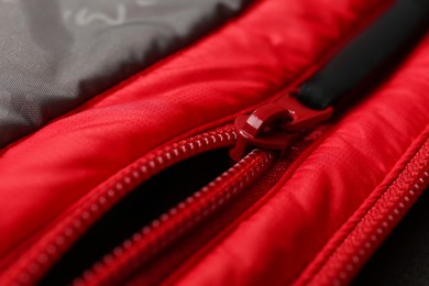 Photo of Red jacket with zipper as background, closeup view