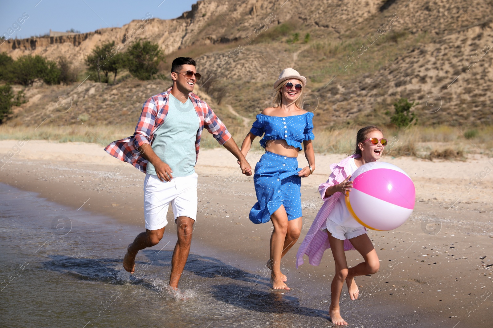 Photo of Happy family at beach on sunny summer day