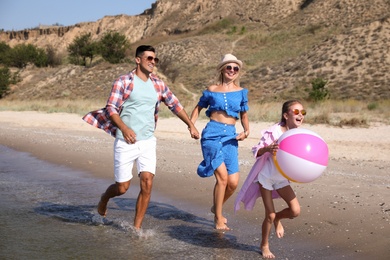 Happy family at beach on sunny summer day