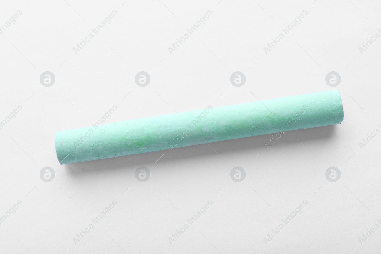 Photo of Piece of green chalk isolated on white, top view