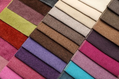 Photo of Fabric samples of different colors as background, top view