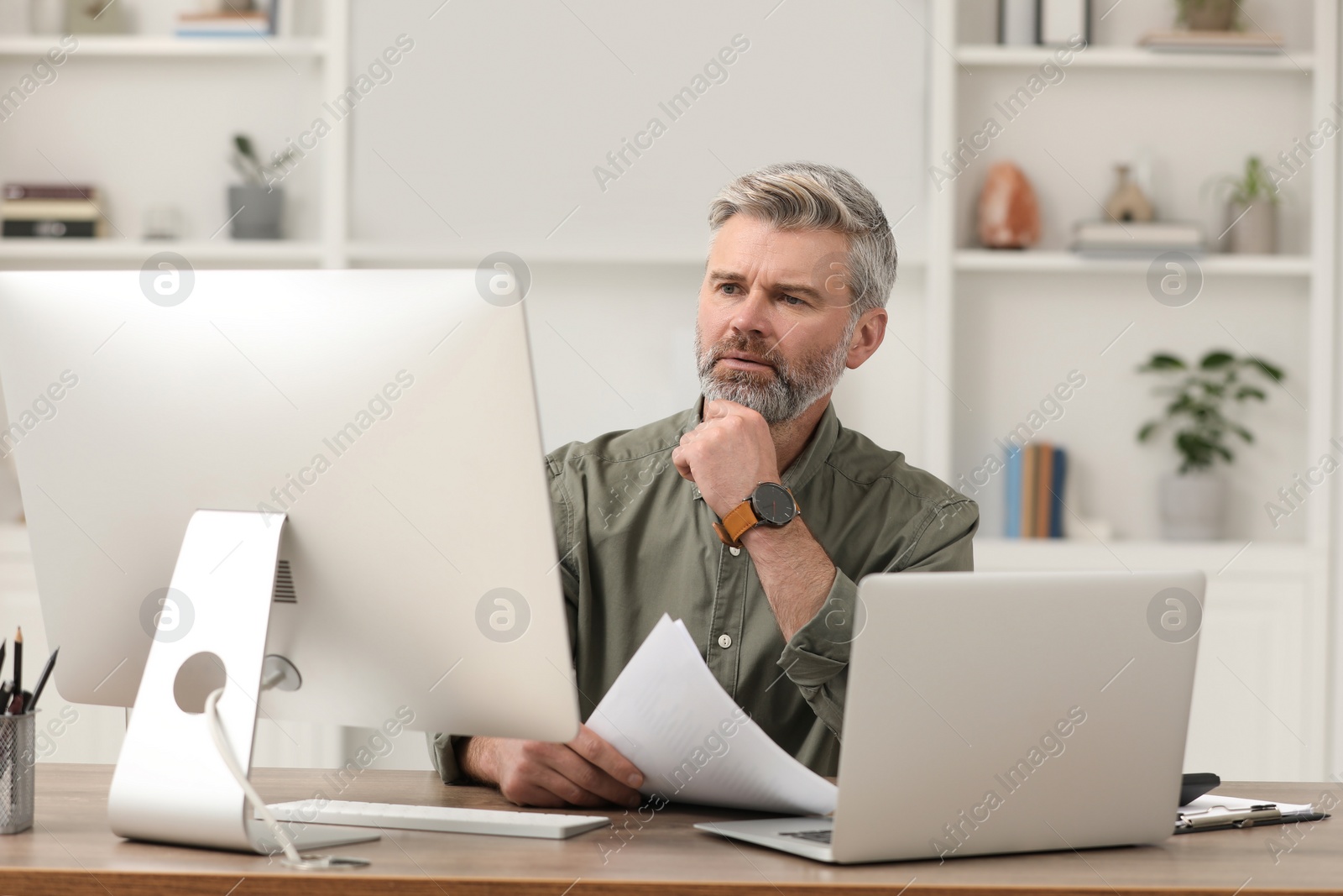 Photo of Professional accountant working at wooden desk in office