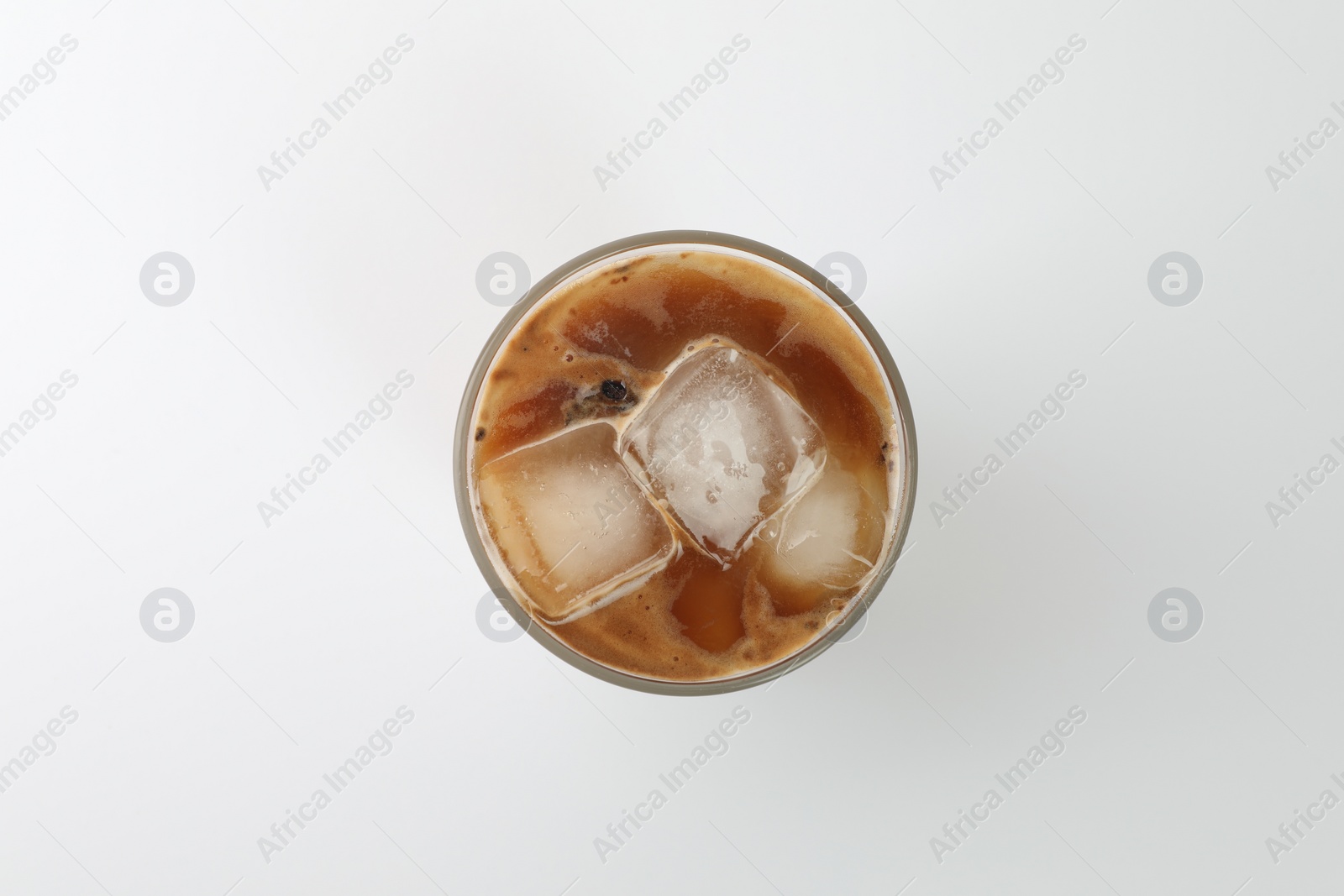 Photo of Iced coffee in glass on white background, top view