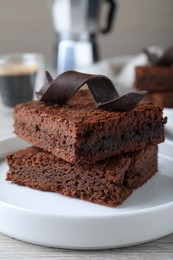 Photo of Delicious chocolate brownies on white table, closeup