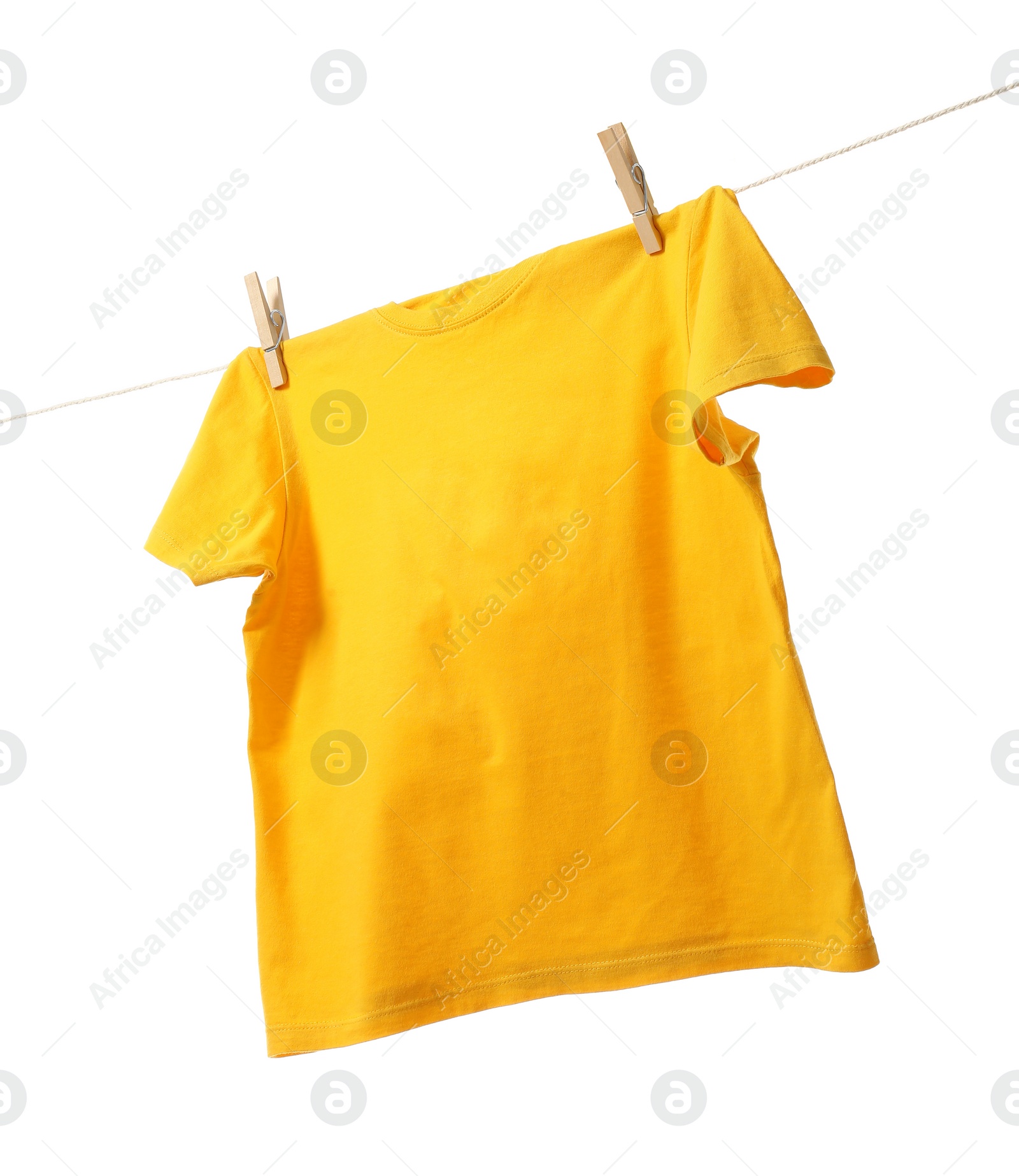 Photo of One yellow t-shirt drying on washing line isolated on white, low angle view