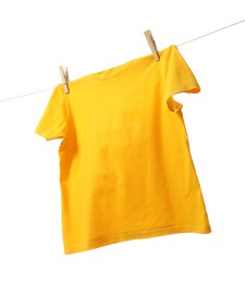 Photo of One yellow t-shirt drying on washing line isolated on white, low angle view