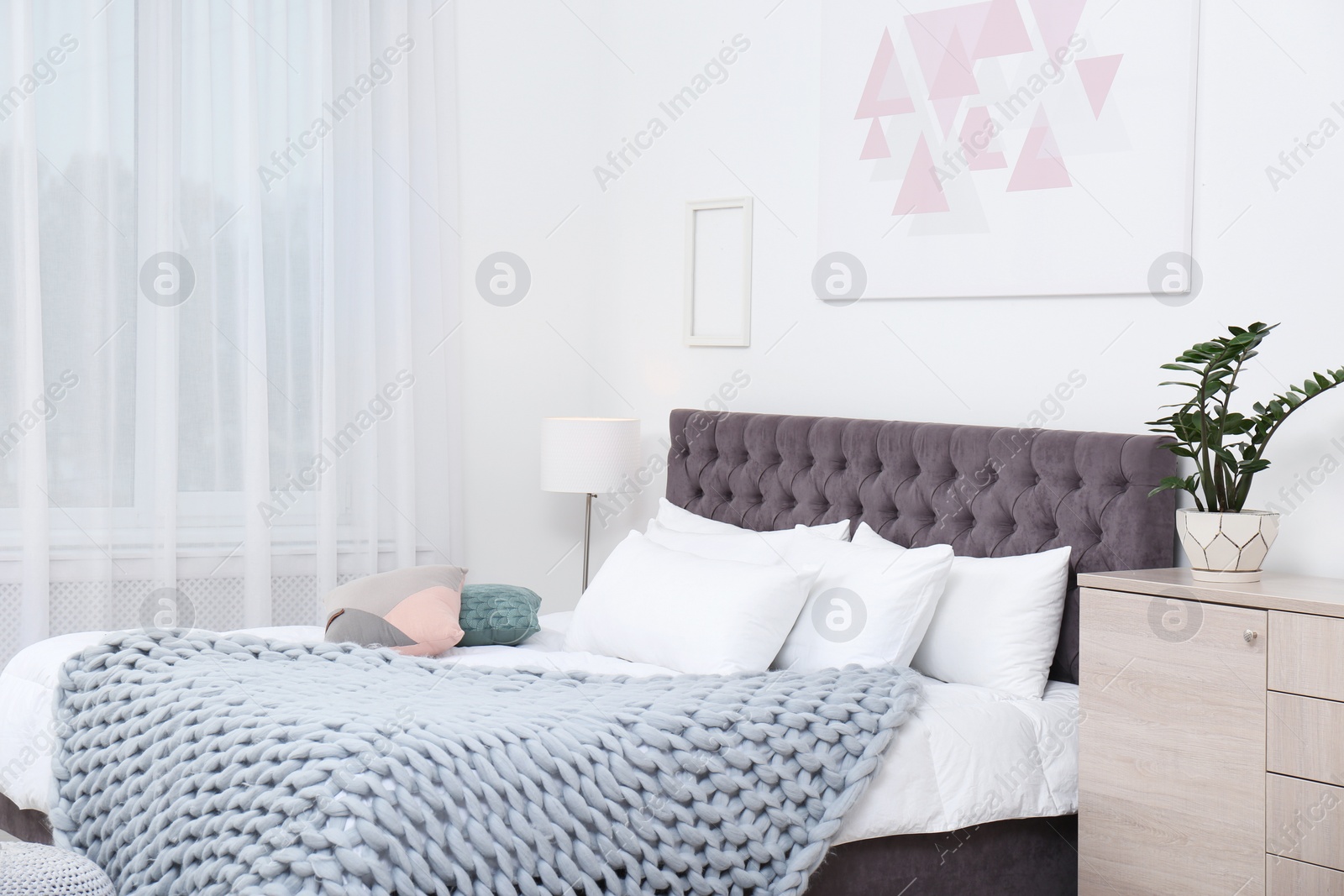 Photo of Stylish room interior with large comfortable bed