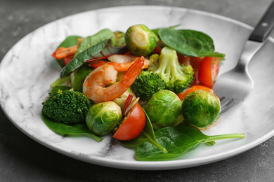 Tasty salad with Brussels sprouts on grey table, closeup