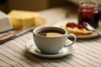 Cup of tasty aromatic tea on table