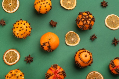 Photo of Flat lay composition with pomander balls made of fresh tangerines on green background