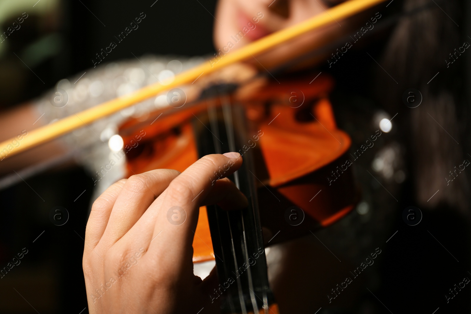 Photo of Woman playing violin at music lesson, closeup