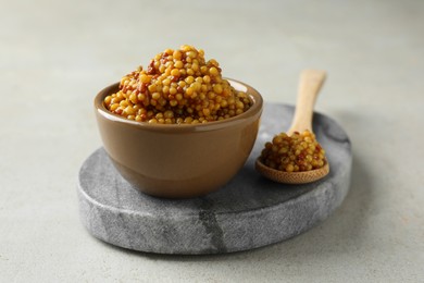 Photo of Bowl and spoon with whole grain mustard on light table