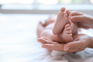 Photo of Mother and her newborn baby on bed, closeup. Space for text