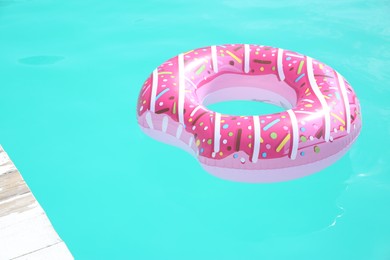 Photo of Inflatable ring in swimming pool on sunny day