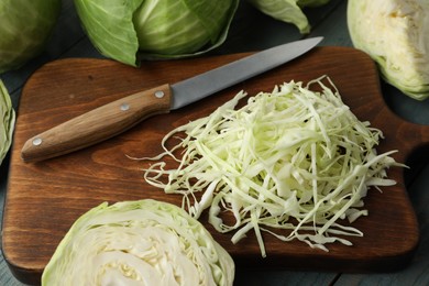 Photo of Chopped ripe cabbage on wooden board, closeup