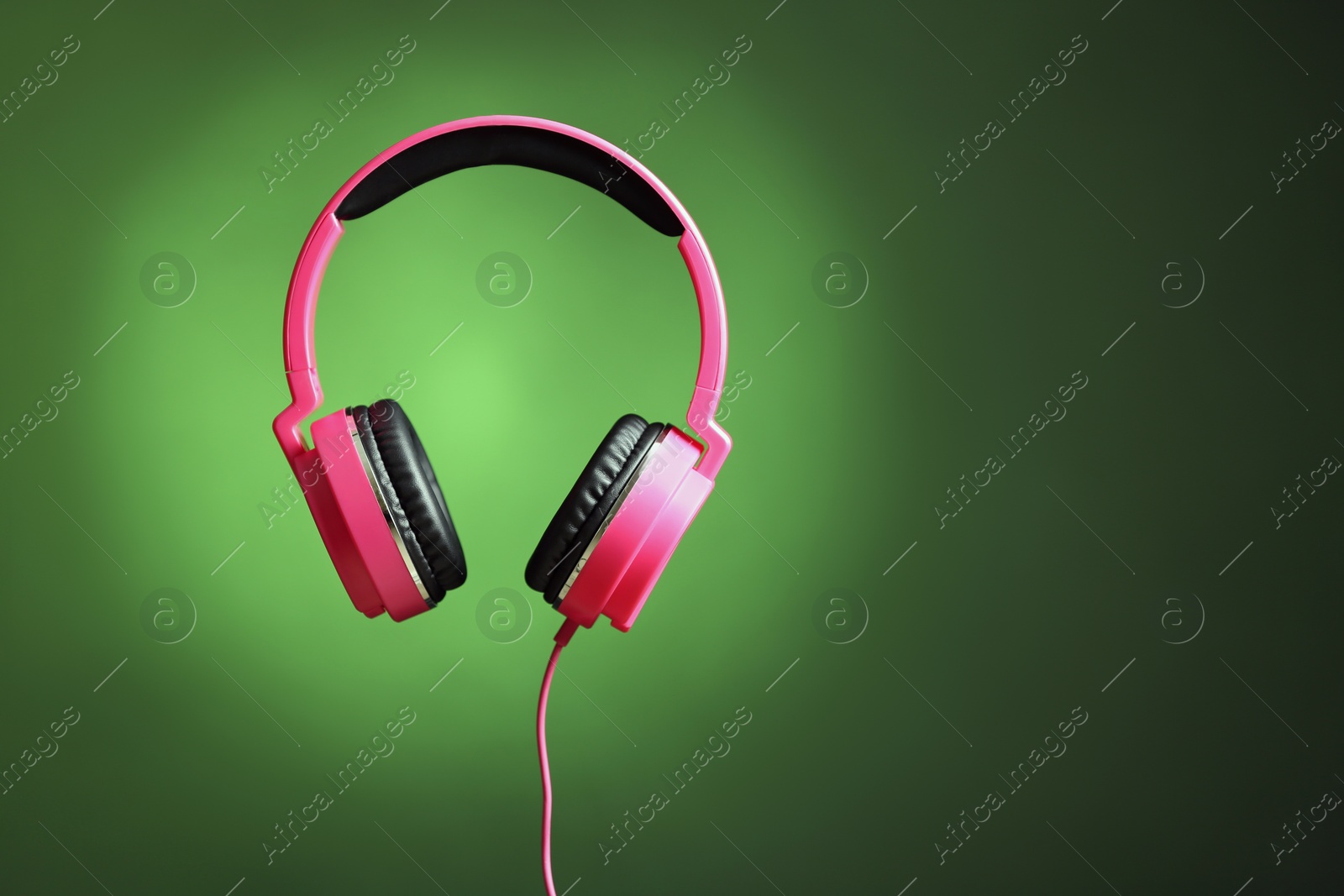 Photo of Stylish headphones on color background. Space for text