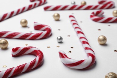 Photo of Many sweet Christmas candy canes and decor on white background