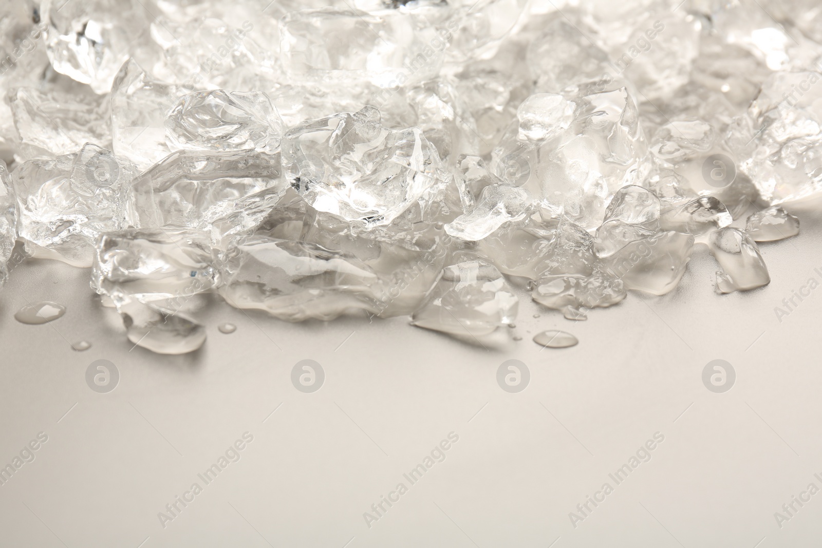 Photo of Pieces of crushed ice on grey background