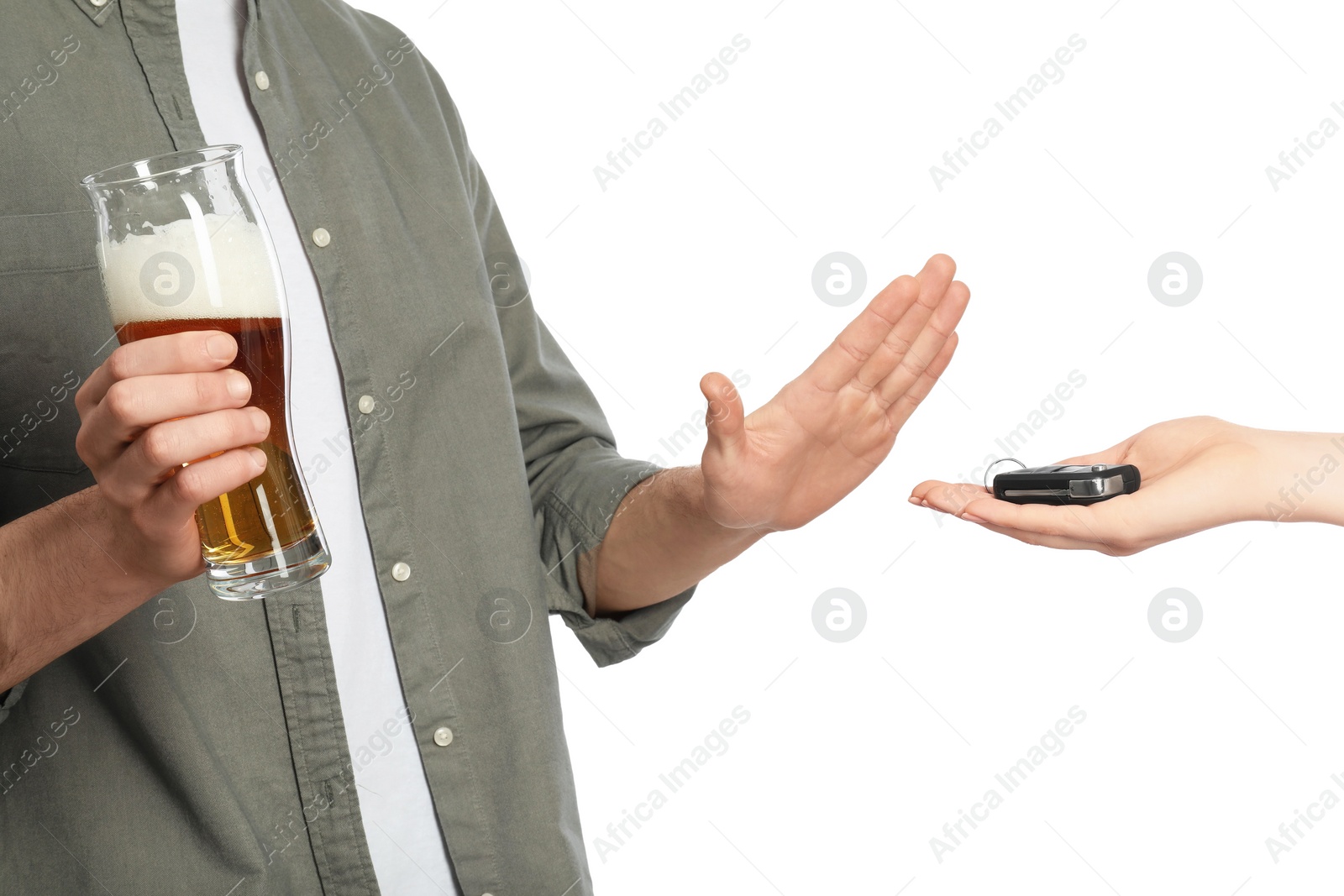 Photo of Man with glass of beer refusing drive car while woman suggesting him keys on white background, closeup. Don't drink and drive concept