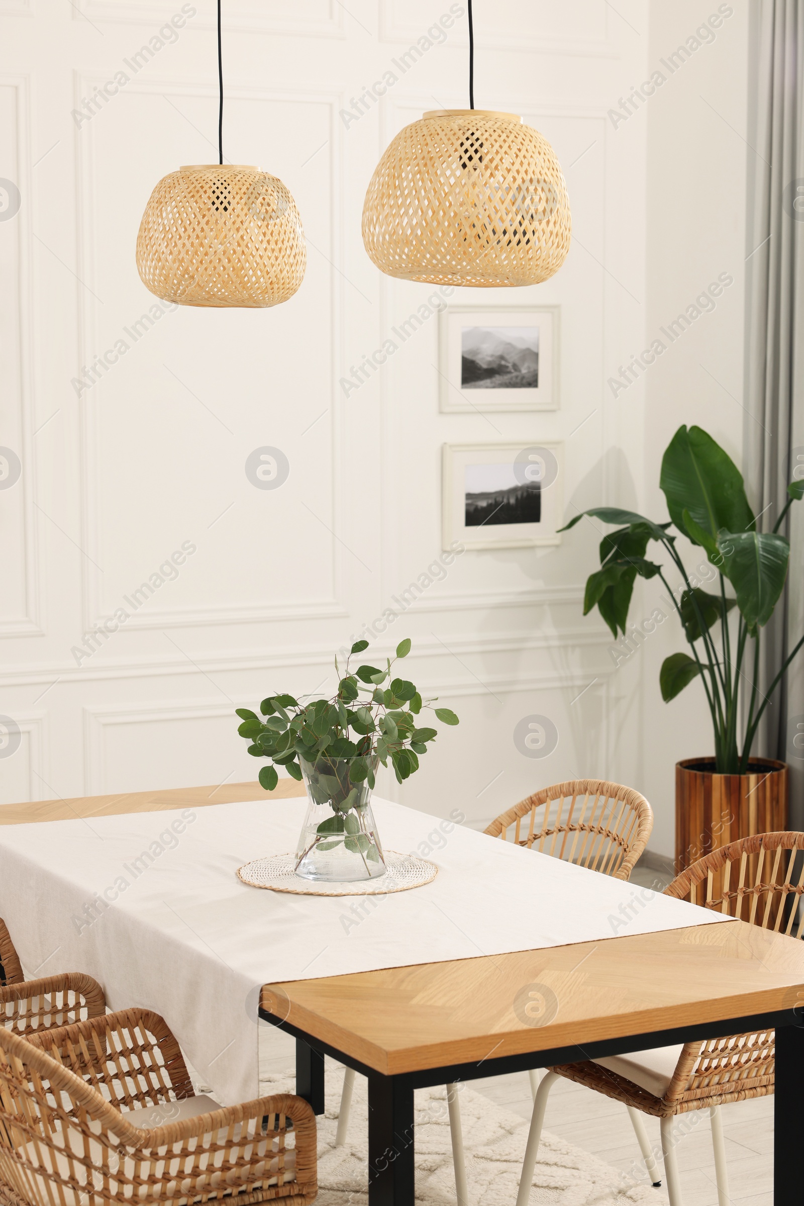 Photo of Stylish dining room with cozy furniture and plants