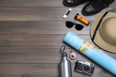 Flat lay composition with safari accessories on wooden background, space for text