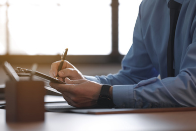 Photo of Male lawyer working at table in office, closeup