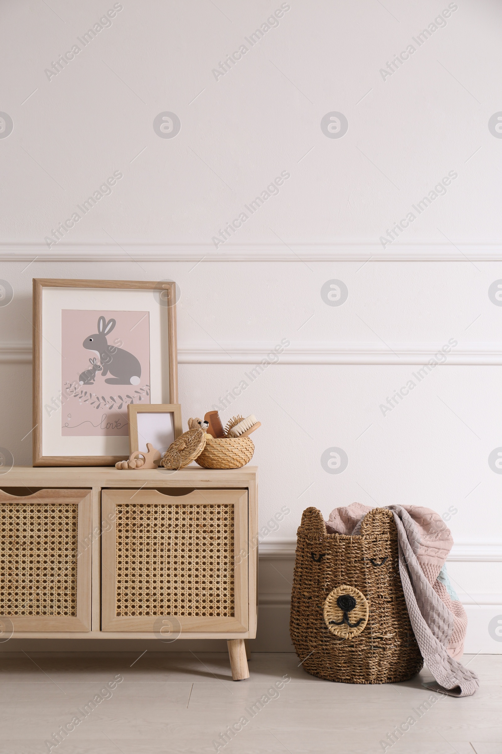 Photo of Modern child room interior with wooden cabinet and different accessories. Space for text