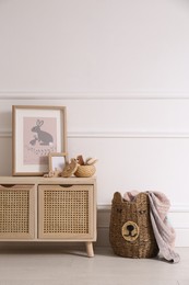 Photo of Modern child room interior with wooden cabinet and different accessories. Space for text