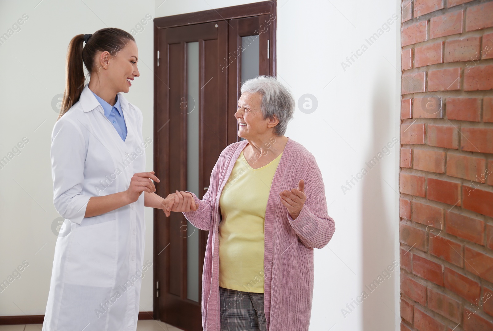 Photo of Doctor helping senior patient at modern clinic