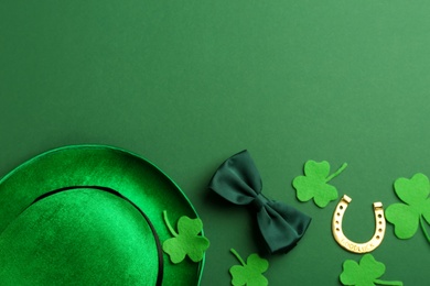 Photo of Leprechaun's hat and St. Patrick's day decor on green background, flat lay. Space for text