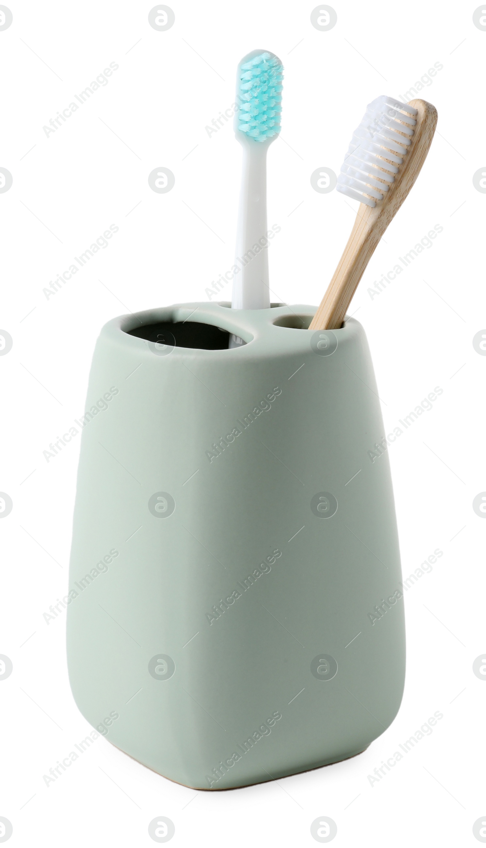 Photo of Bath accessory. Ceramic holder with toothbrushes isolated on white