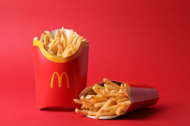 Photo of MYKOLAIV, UKRAINE - AUGUST 12, 2021: Two big portions of McDonald's French fries on red background